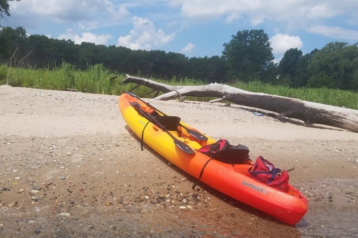 a boat sitting on top of a sandy beach