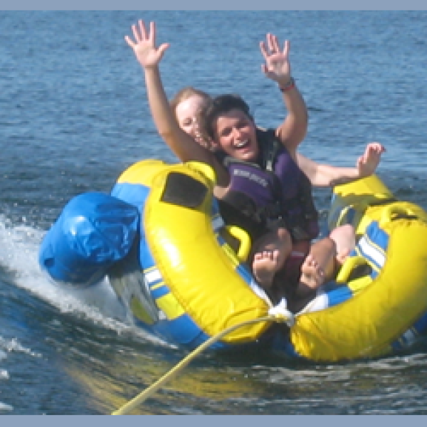 a group of people on a raft in a body of water