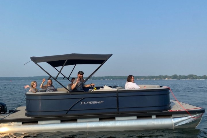 a group of people in a small boat in a body of water