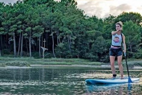 a girl riding a wave on a surfboard in the water